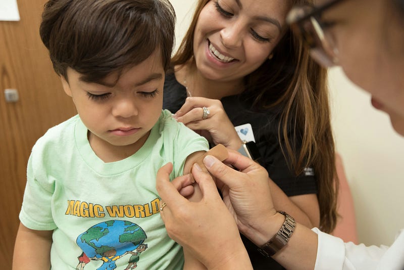 A nurse comforting a child during a medical emergency