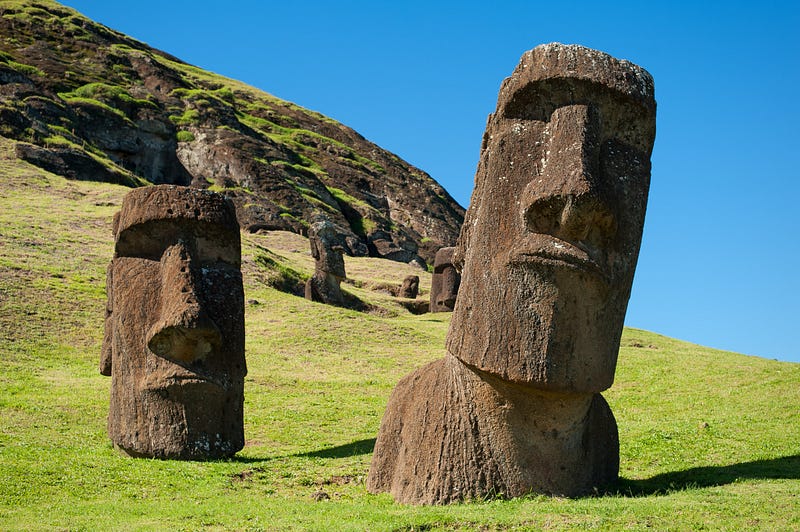 Scattered Moai statues symbolizing cultural loss