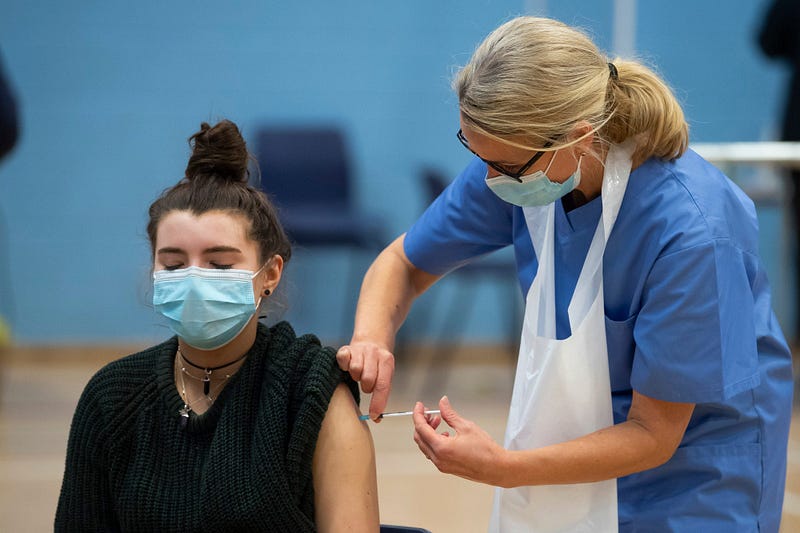 Woman receiving COVID-19 vaccine in Wales